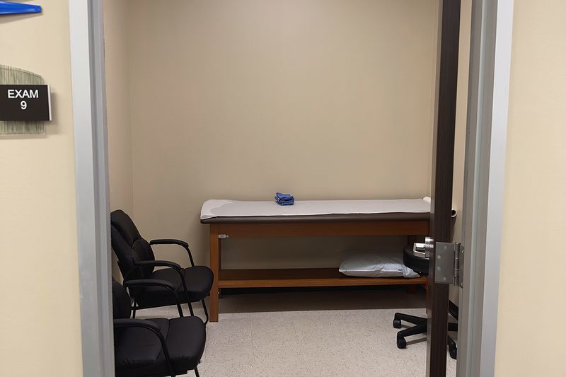 An exam room at our Plano office, with an exam table and two chairs.