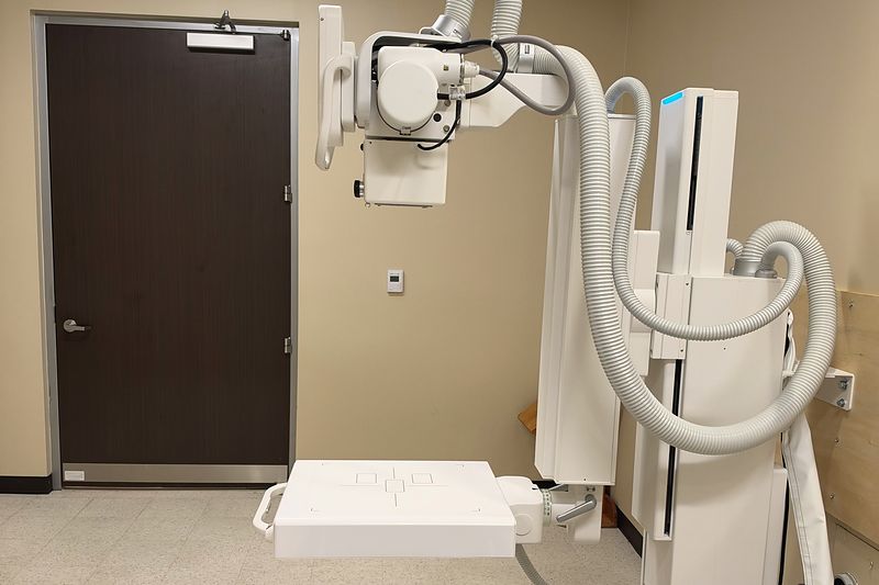 The X-ray room at our Plano office, with the X-ray arm and a chair for the patient.