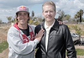 Dr. Knight standing with a professional motorsport athlete he treated.