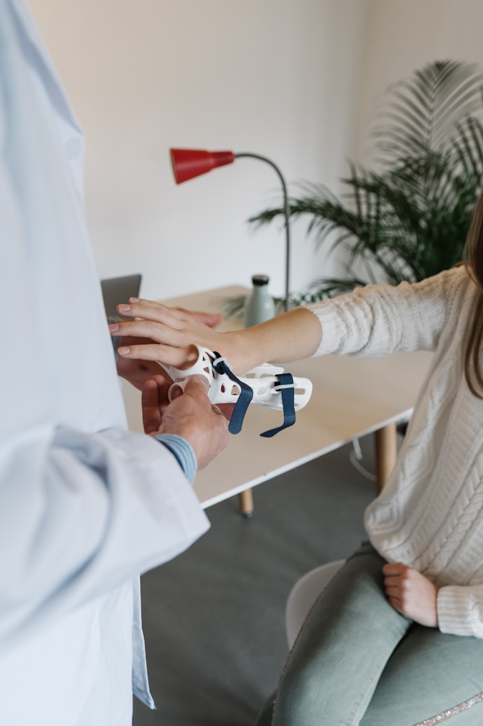 A wrist brace being fitted to a person’s hand.