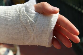 Hand and wrist area properly wraped in a medical bandage.