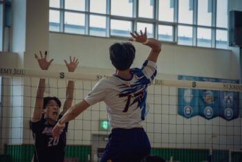 young man playing indoor volleyball